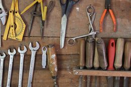 table filled with different tools like wrenches and screwdrivers 